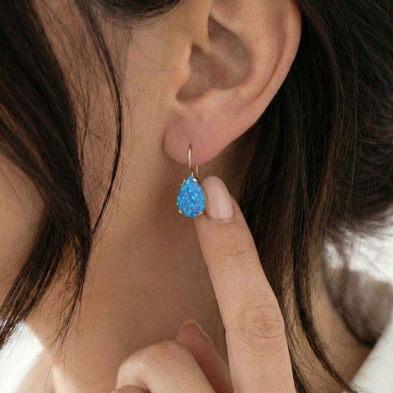 עגילי זהב 14 קראט טיפה אבן אופל כחול