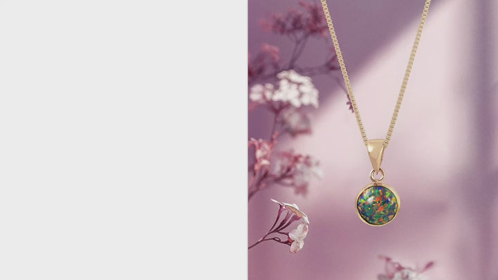 Круглый кулон из черного опала и желтого золота.